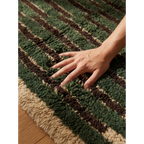 Soft hand-knotted wool texture of the Itri green Moroccan rug.
