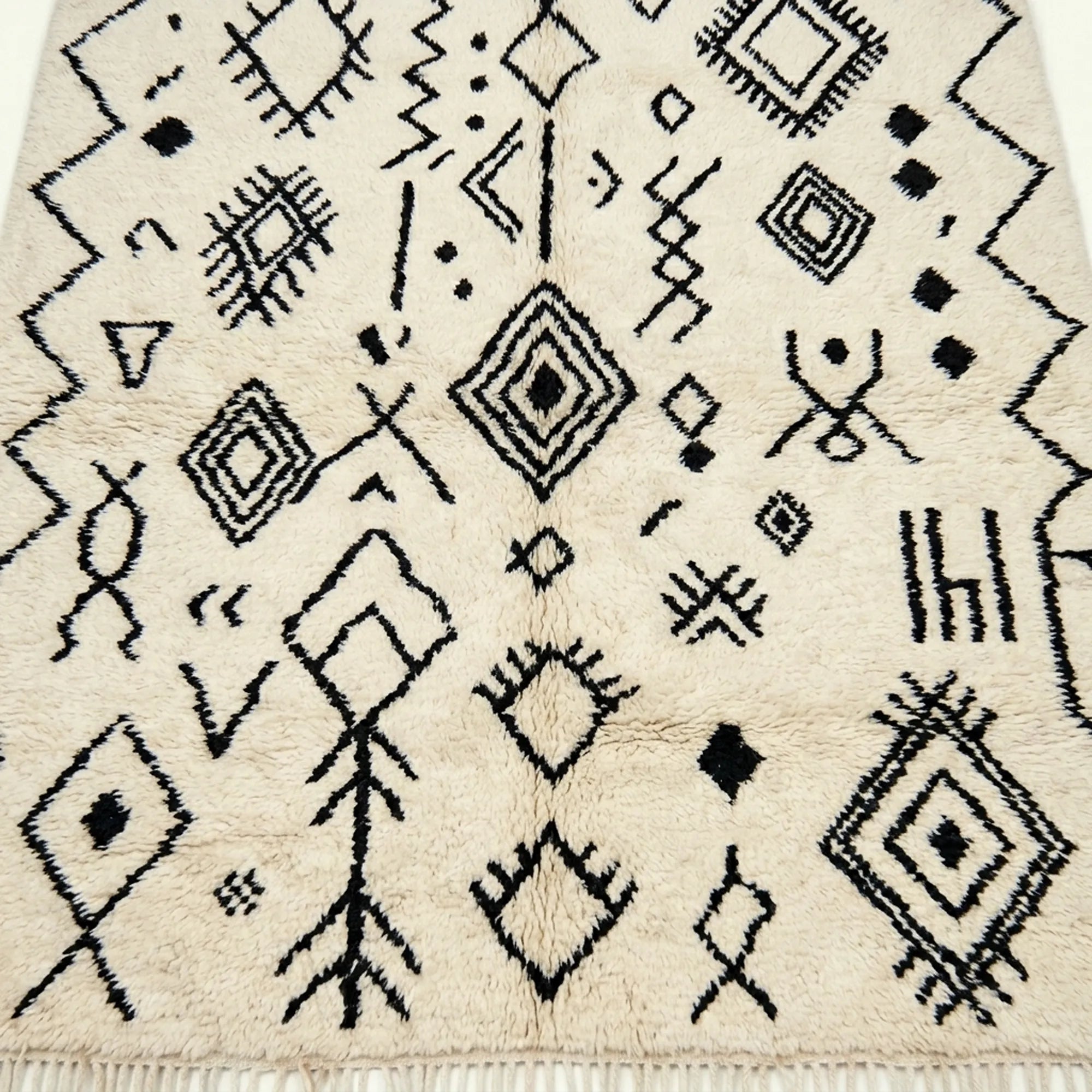 Ivory Azilal rug Afelki with black tribal pattern, wool texture detail