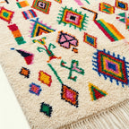 Ivory Azilal rug Afella with vivid multicolor symbols, pattern detail