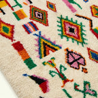 Ivory Azilal rug Afella with vivid multicolor symbols, wool texture detail