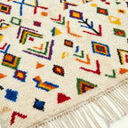 Ivory Azilal rug Amezri with multicolor symbol mosaic, wool texture detail
