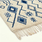 Ivory Azilal rug Imnayen with blue tribal diamonds, craftsmanship detail