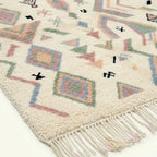 Ivory Azilal rug Tamazla with pastel tribal pattern, fringe detail