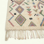 Ivory Azilal rug Tamazla with pastel tribal pattern, craftsmanship detail