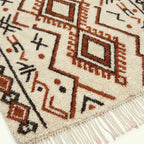 Ivory Azilal rug Tazirit with rust diamond border, fringe detail