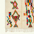 Ivory Azilal rug Tuda with multicolor stripe diamonds, wool texture detail