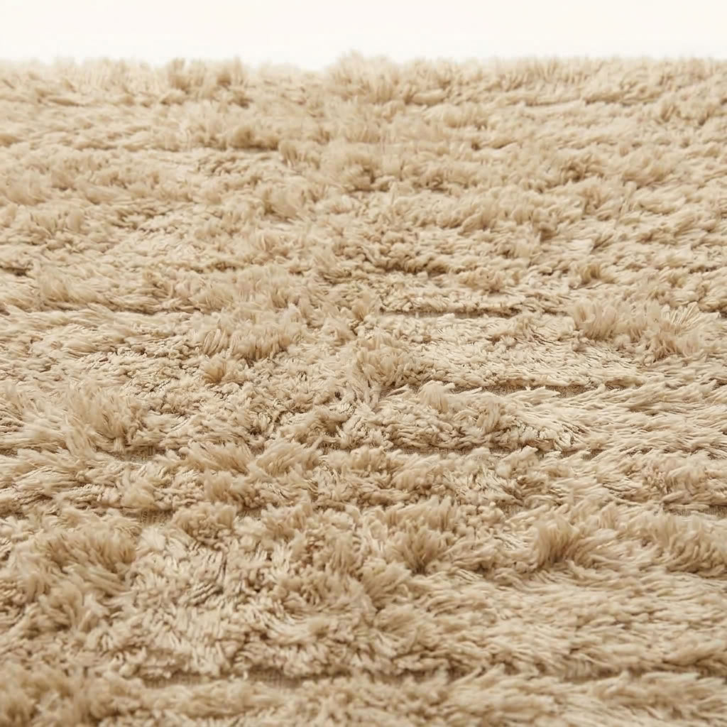 Close-up of ivory Beni Ourain pile texture showing horizontal stripe weave detail