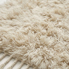 Macro view of ivory Beni Ourain handwoven knotted texture with natural variations