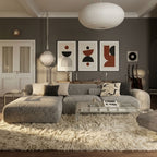Ivory Beni Ourain rug in modern living room setting with curved grey sofa and abstract wall art