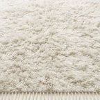 Close-up texture detail of Ivory Beni Ourain rug showing thick wool pile and natural tonal variation
