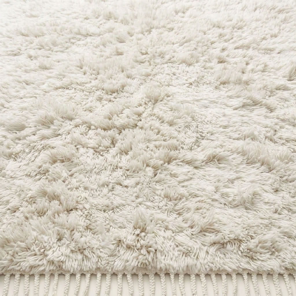 Close-up texture detail of Ivory Beni Ourain rug showing thick wool pile and natural tonal variation