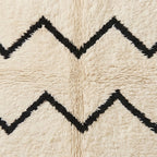 Close-up of chevron lines showing hand-knotted wool construction with black and ivory contrast