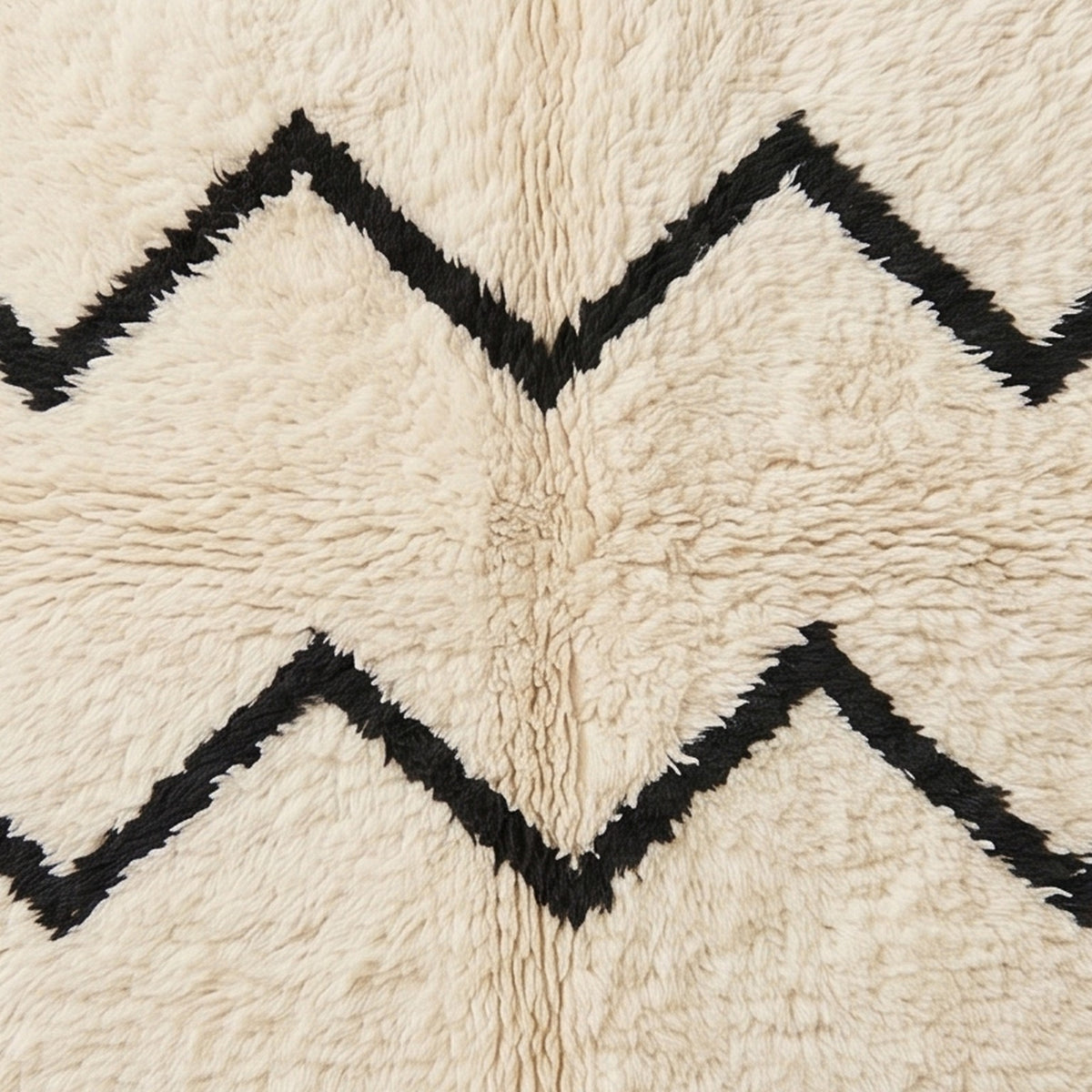 Close-up of chevron lines showing hand-knotted wool construction with black and ivory contrast