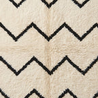 Detailed view of chevron stripe pattern in hand-knotted Beni Ourain wool showing texture and depth