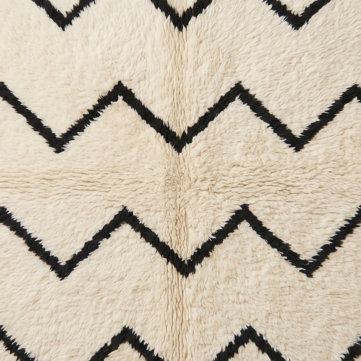 Detailed view of chevron stripe pattern in hand-knotted Beni Ourain wool showing texture and depth