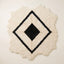 Ivory and black Beni Ourain rug with nested diamond lattice design and irregular scalloped edges, full flat view
