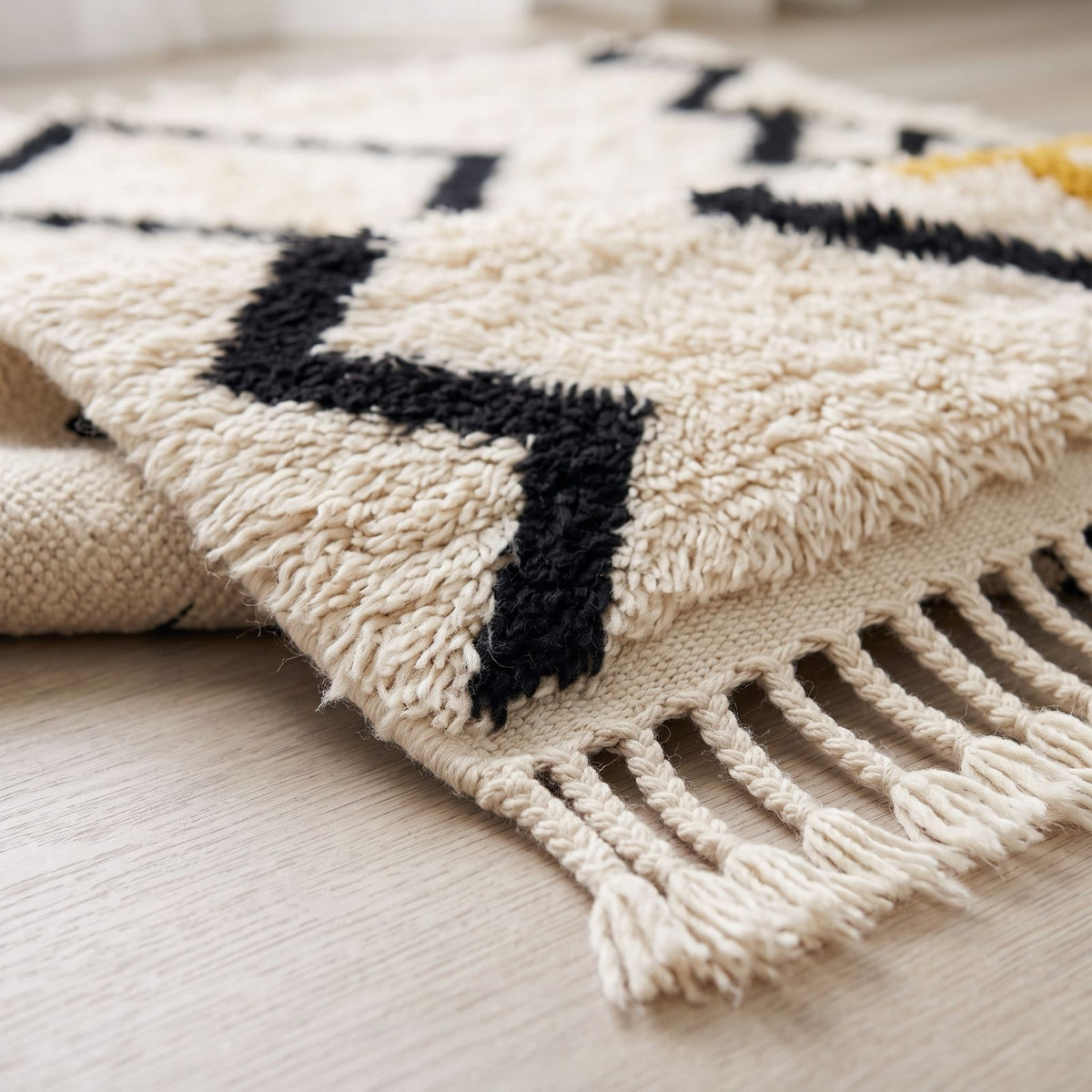 Cream wool fringe and black chevron border edge detail on Beni Ourain rug