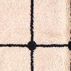 Cream wool fringe edge and grid pattern detail