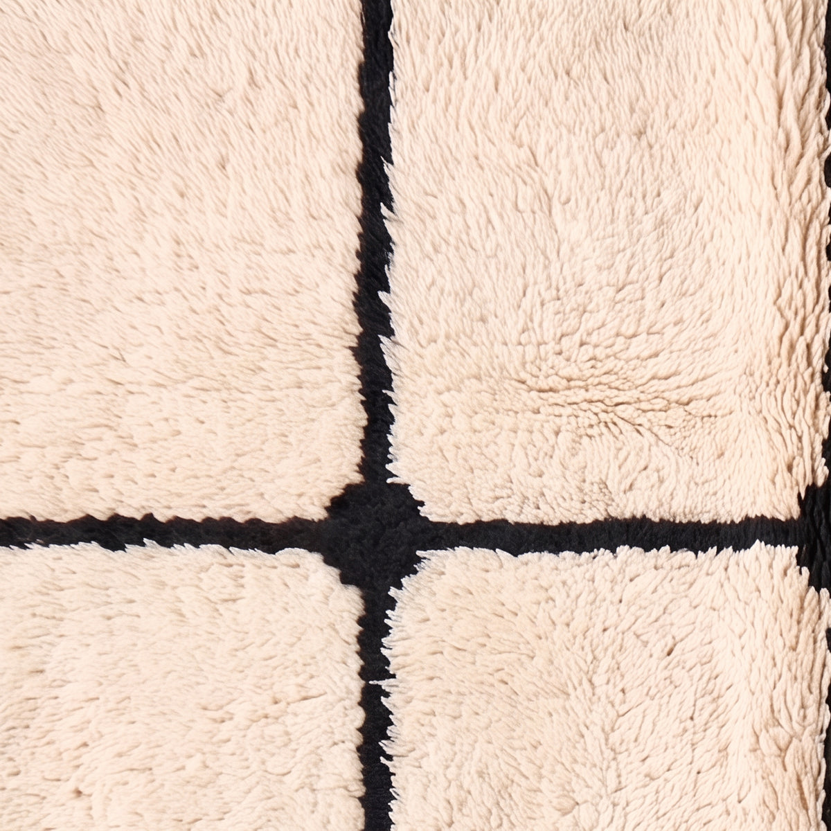 Cream wool fringe edge and grid pattern detail