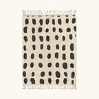 Full view of the Tissa ivory and black Beni Ourain rug with an oval grid design.