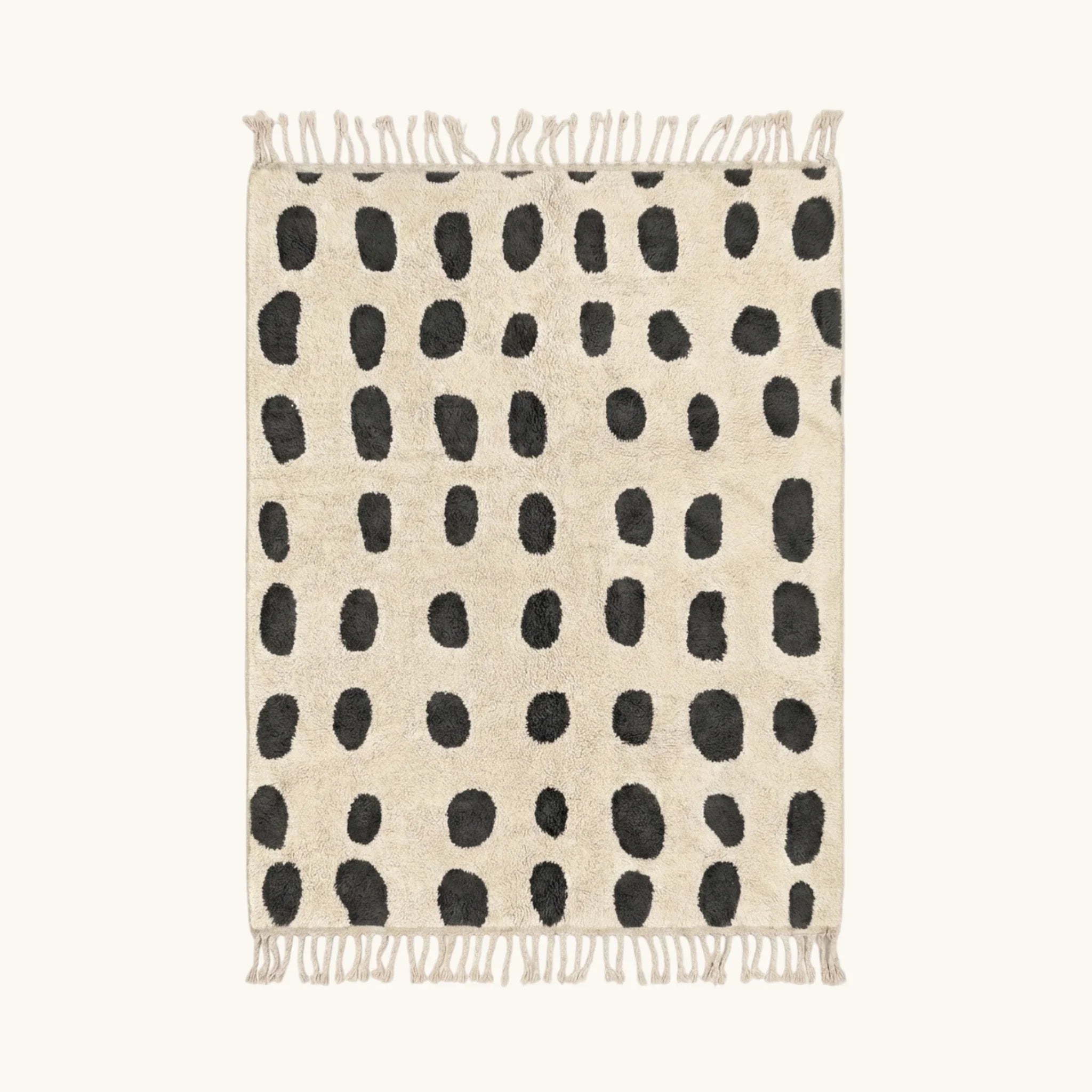 Full view of the Tissa ivory and black Beni Ourain rug with an oval grid design.