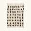 Full view of the Tissa ivory and black Beni Ourain rug with an oval grid design.