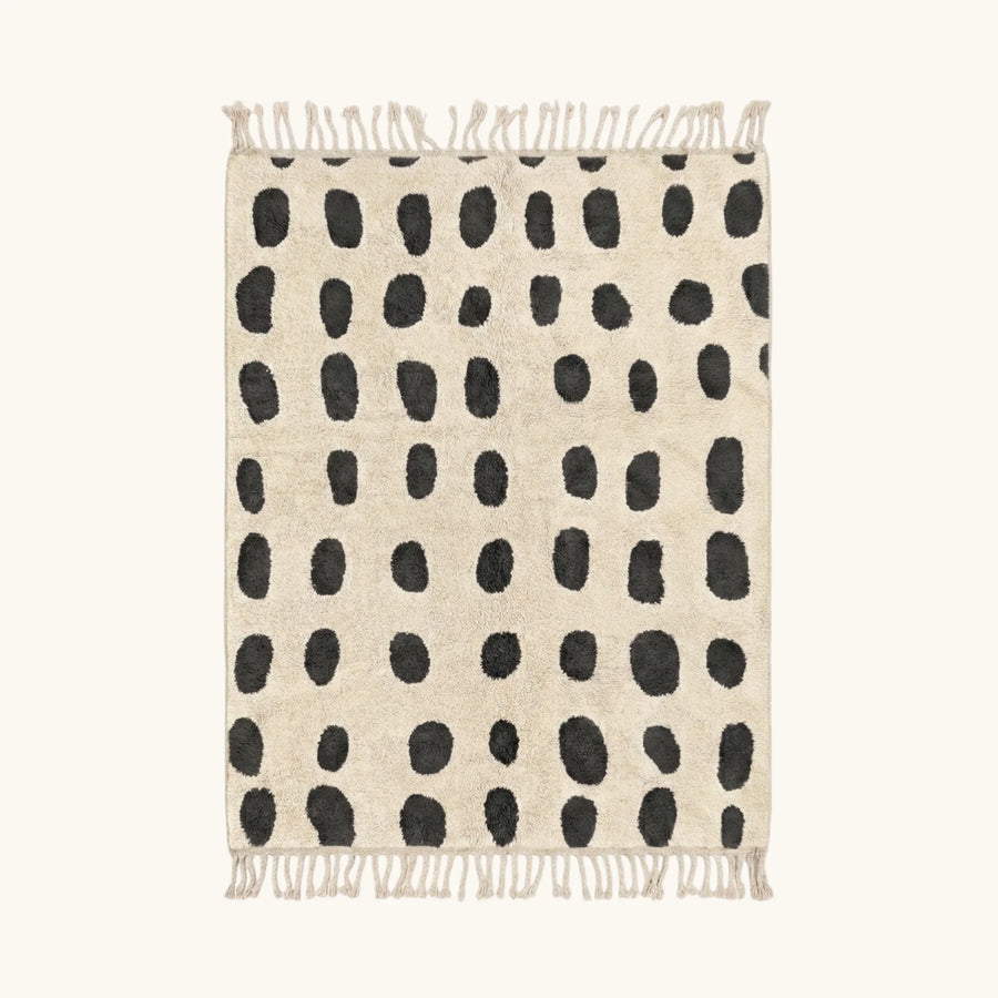 Full view of the Tissa ivory and black Beni Ourain rug with an oval grid design.