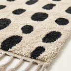 Close-up of the natural Atlas wool pile and edge on the Tissa ivory and black Beni Ourain rug.