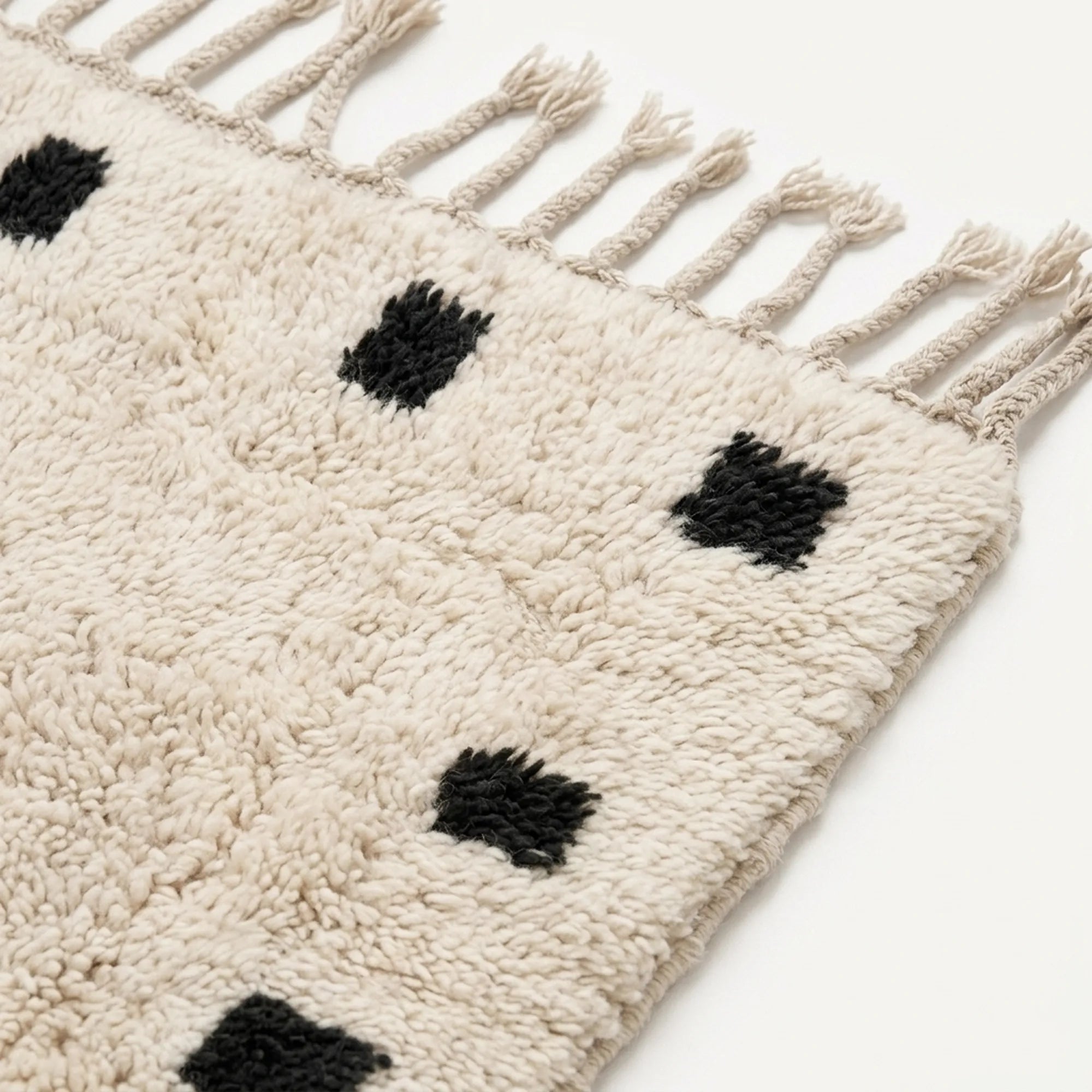 Fringe and border detail of the ivory and black Moroccan wool rug.