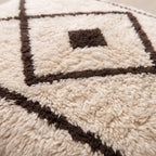 Close-up of the beni lines pattern on the Amayas Moroccan wool pillow