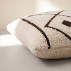 Side view of the Amayas Moroccan pillow showing its ivory and black wool pile