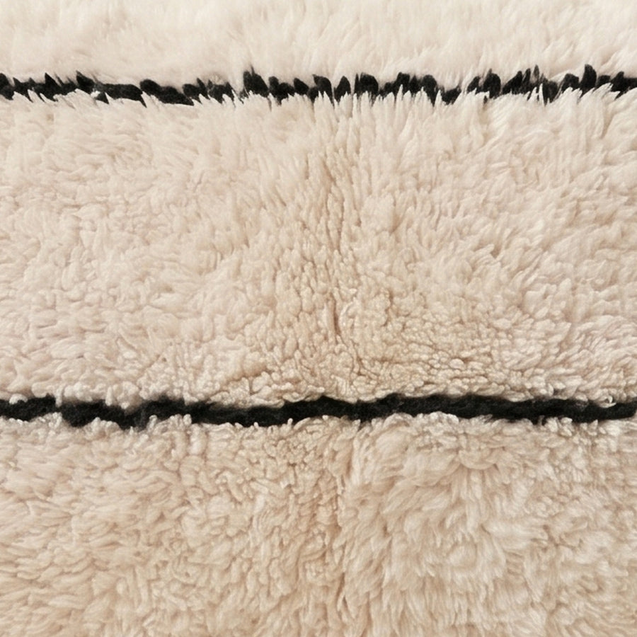 Close-up of the hairline grid pattern on the Tidi Moroccan wool pillow