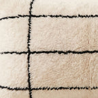 Side view of the Tidi Moroccan pillow showing its ivory and black wool pile