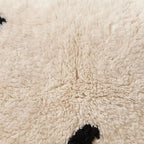 Close-up of the minimal marks pattern on the Azul Moroccan wool pillow
