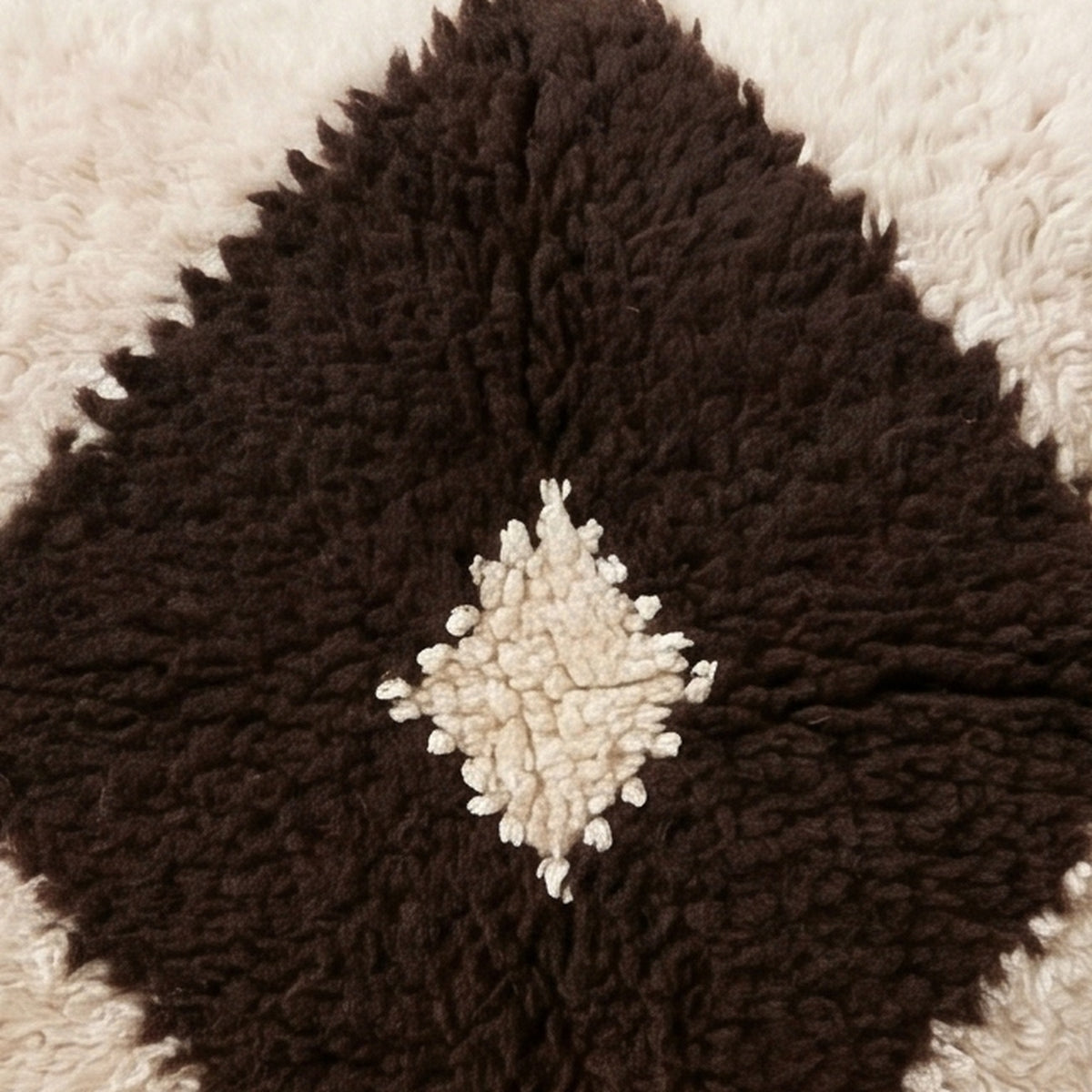 Close-up of the single eye pattern on the Tit Moroccan wool pillow