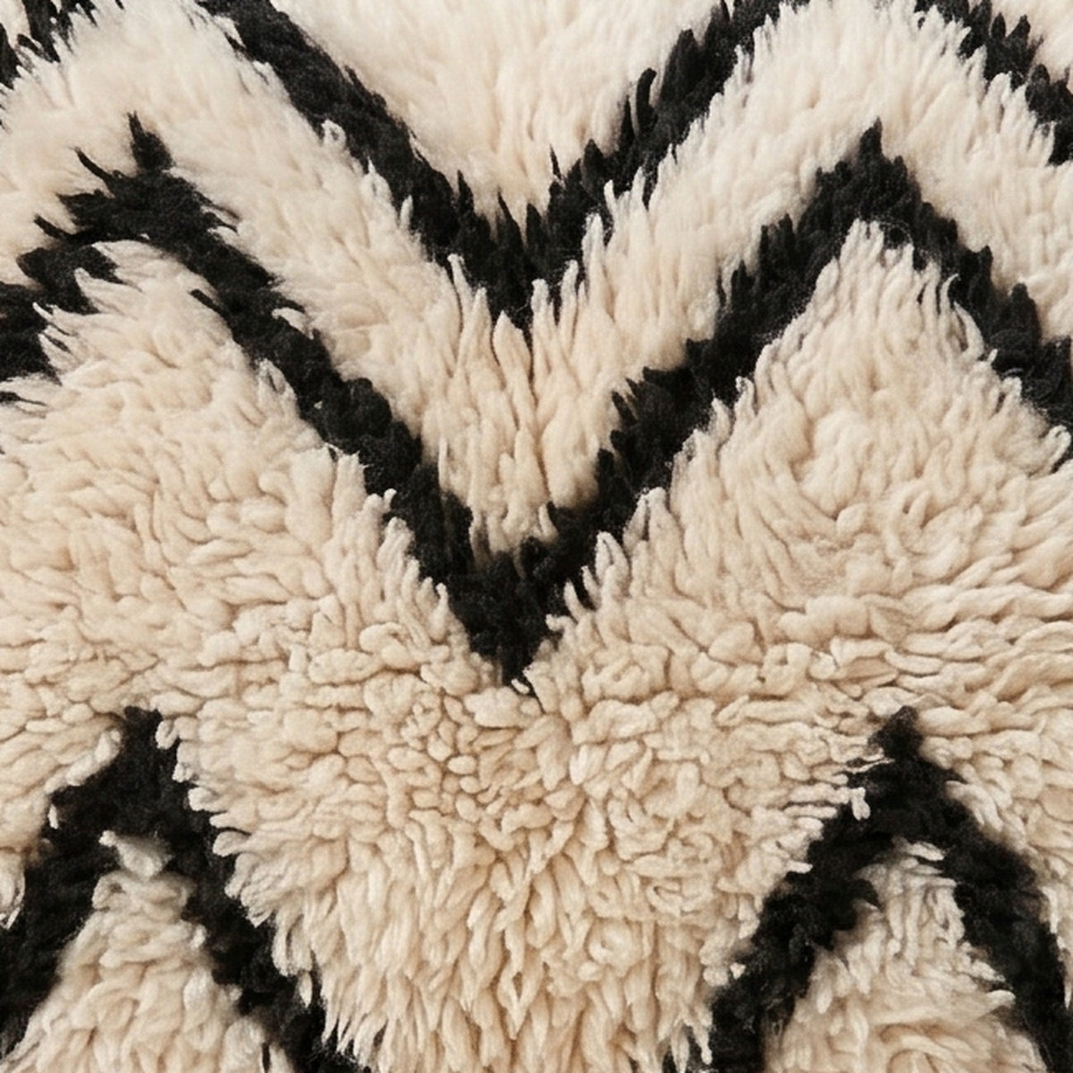 Close-up of the water lines pattern on the Aman Moroccan wool pillow