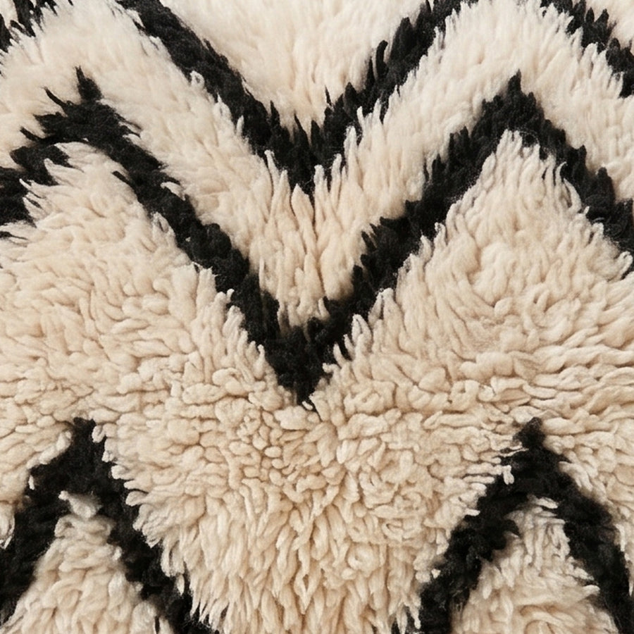 Close-up of the water lines pattern on the Aman Moroccan wool pillow