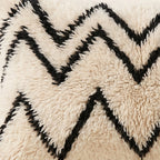 Side view of the Aman Moroccan pillow showing its ivory and black wool pile