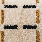 Close-up of the dash grid pattern on the Tazart Moroccan wool pillow