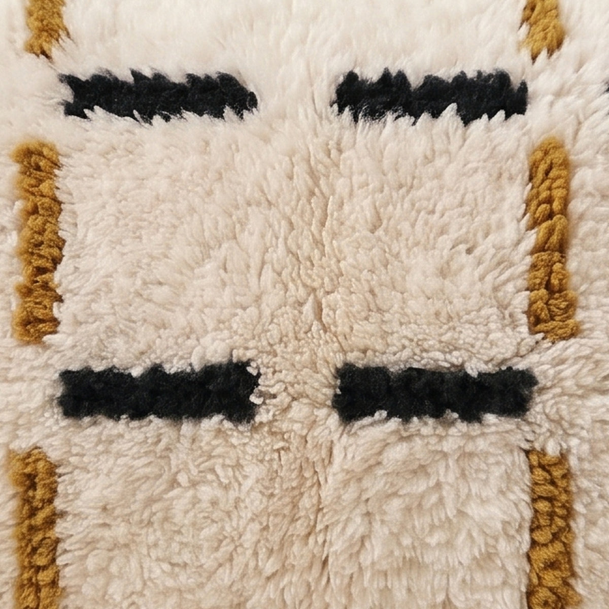 Close-up of the dash grid pattern on the Tazart Moroccan wool pillow