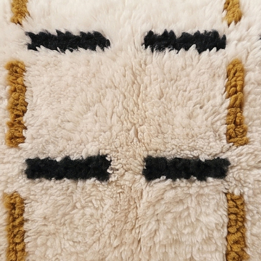 Close-up of the dash grid pattern on the Tazart Moroccan wool pillow