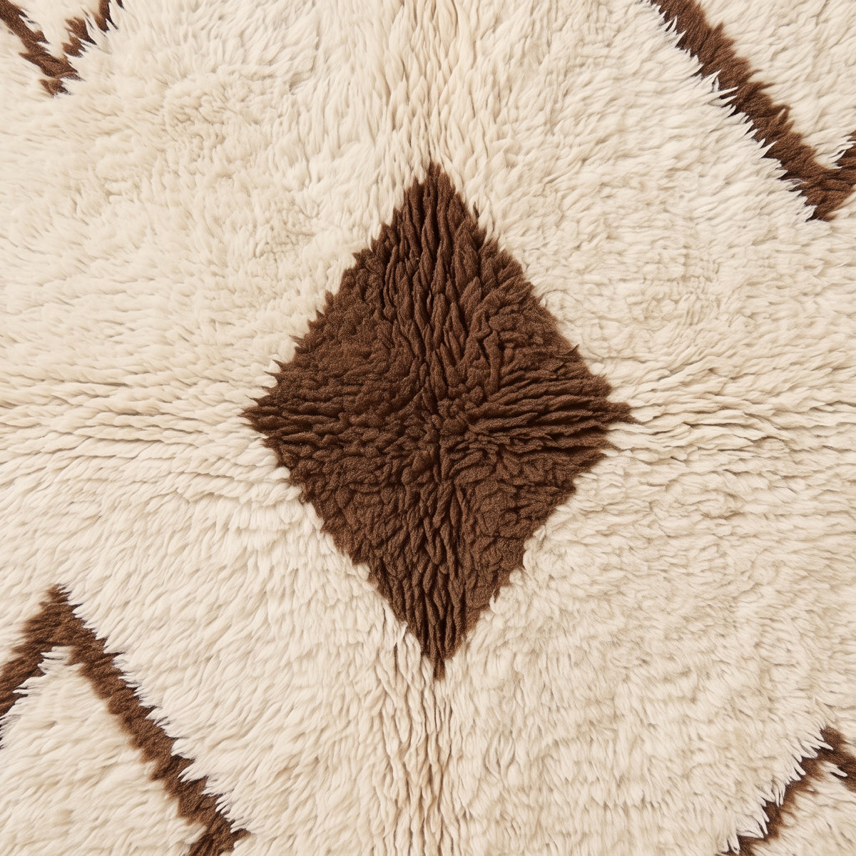 Textured close-up of brown diamond motif with surrounding ivory pile detail