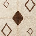 Detail of hollow diamond outline and central filled diamond on soft ivory pile