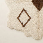 Edge detail showing organic fringe and wavy border of irregular Beni Ourain rug