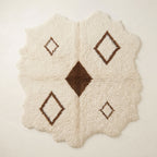 Ivory Beni Ourain rug with brown diamond lattice, full flat view showing irregular organic edges