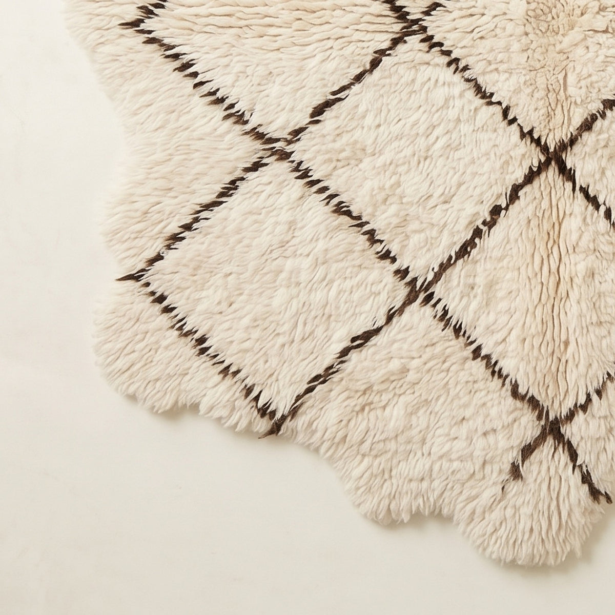 Fringe edge detail on corner of ivory Beni Ourain rug Ifri with brown lattice