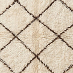 Textured close-up showing hand-knotted construction and wool pile of Ifri rug