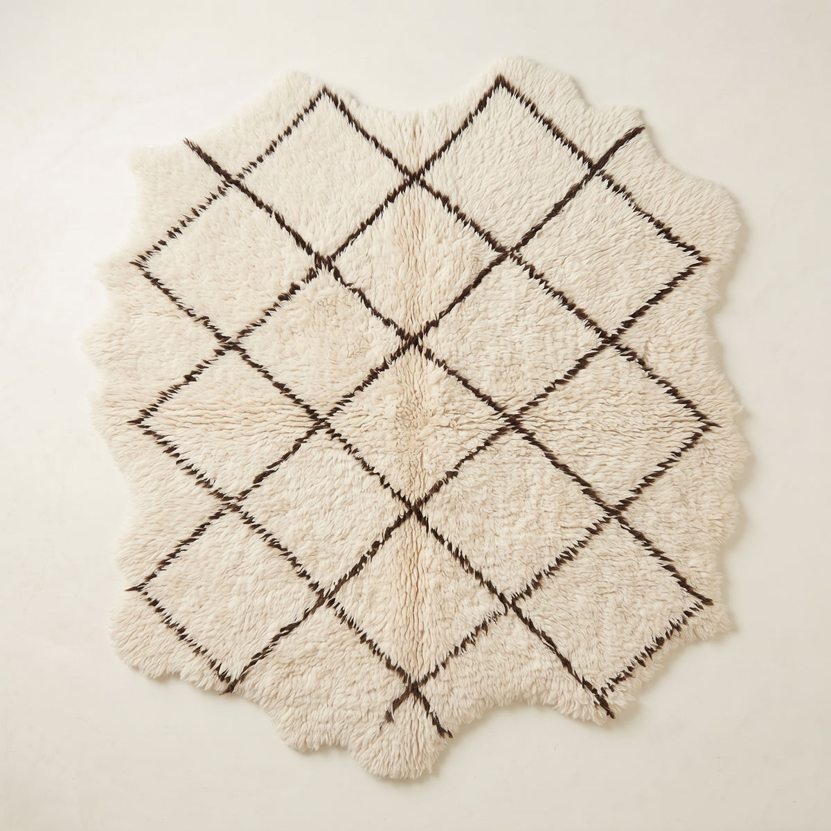 Ivory Beni Ourain rug Ifri with brown open lattice diamond design, flat lay on white background