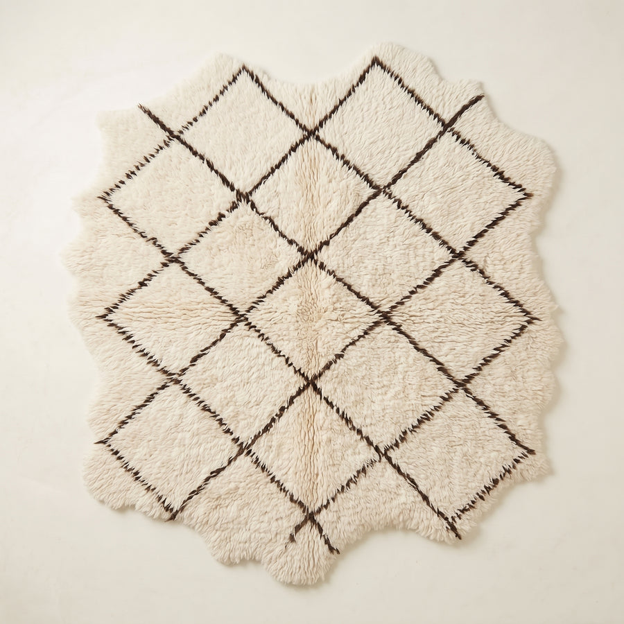 Ivory Beni Ourain rug Ifri with brown open lattice diamond design, flat lay on white background