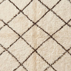 Macro detail of open lattice geometric pattern on ivory Beni Ourain rug